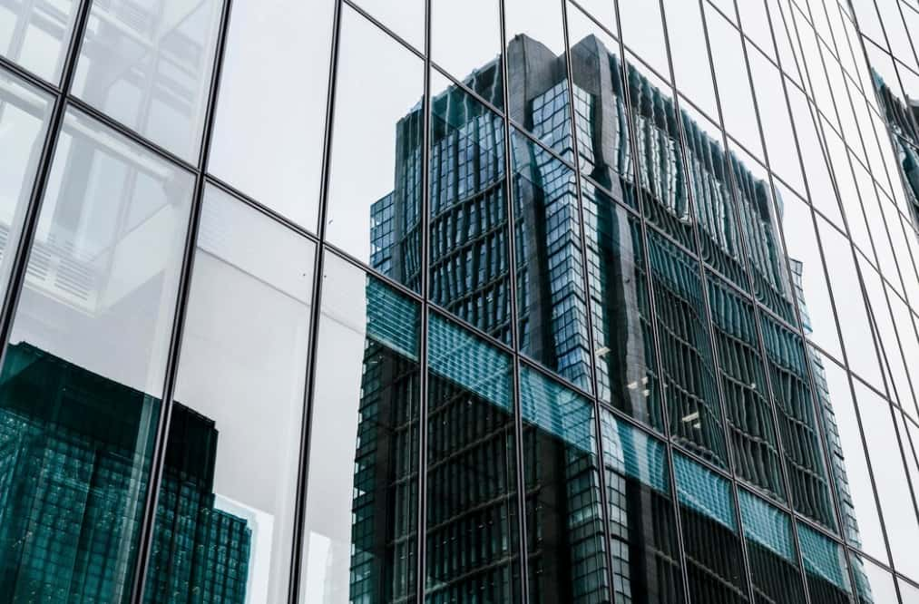 Reflections on the glass facade of a modern skyscraper