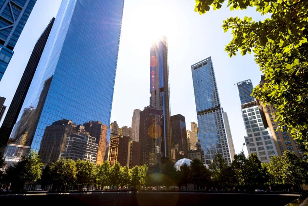 Modern skyscrapers under a clear sky with sun flare in the foreground